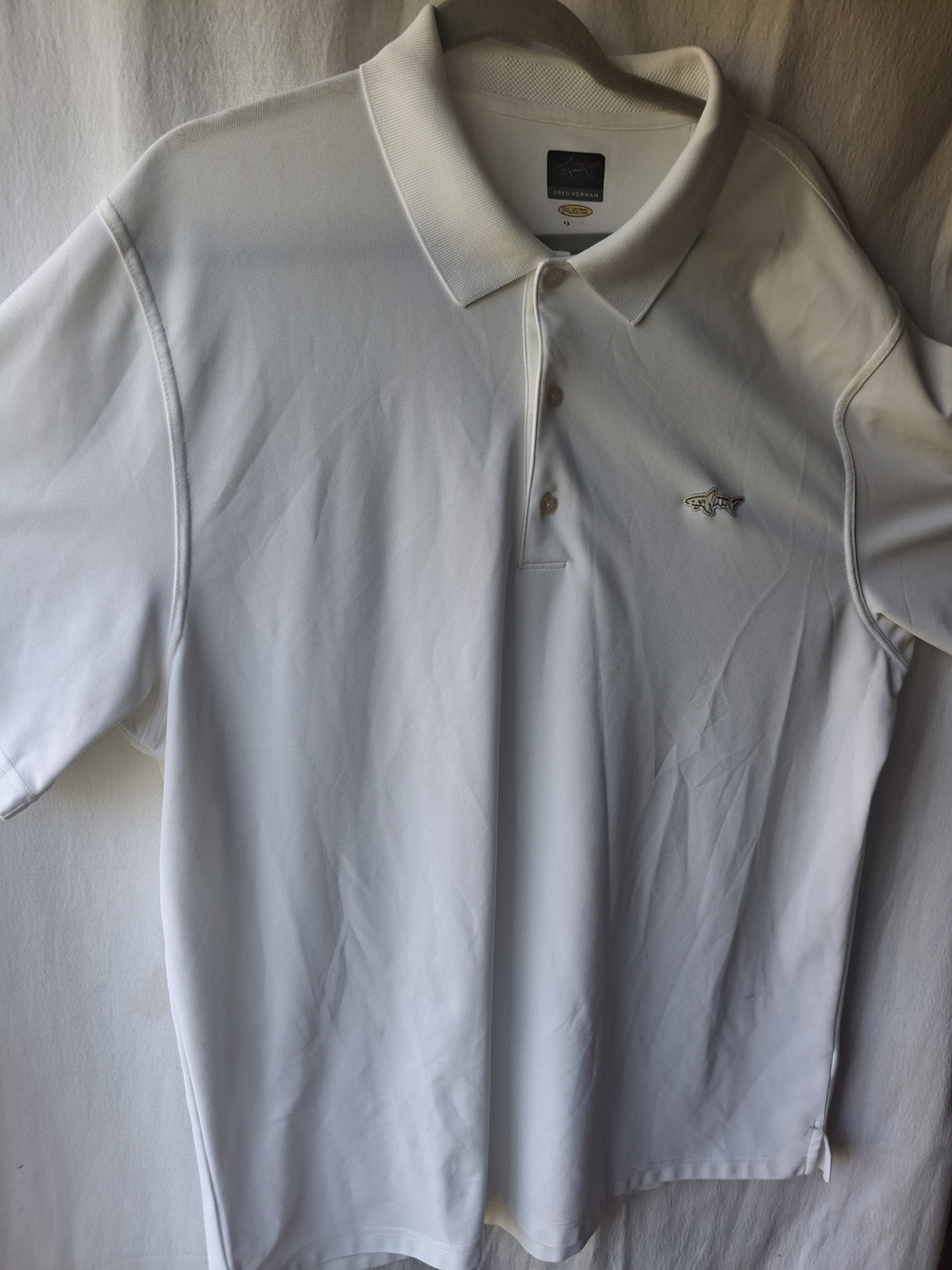 Greg Norman Collection White Polo with Shark Emblem